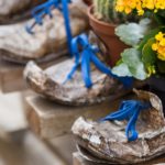 71983441 - old shoes covered with vases of flowers inside
